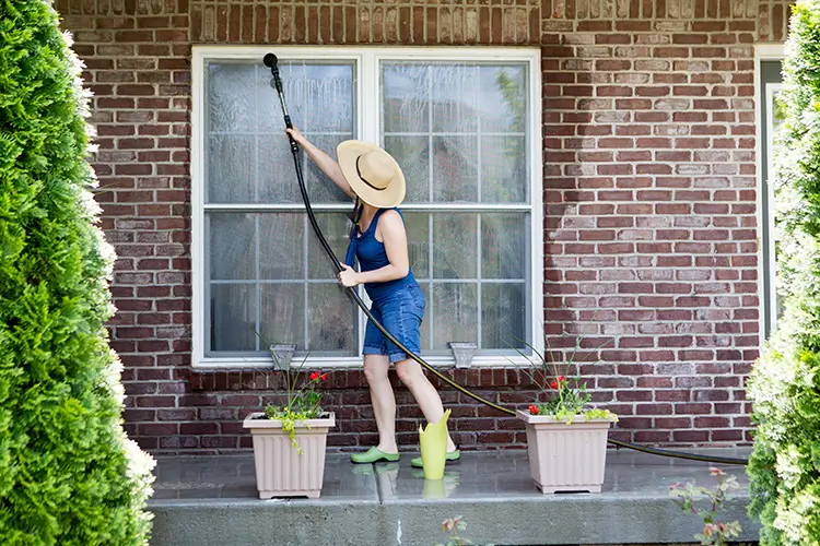 Woman cleaning exterior window