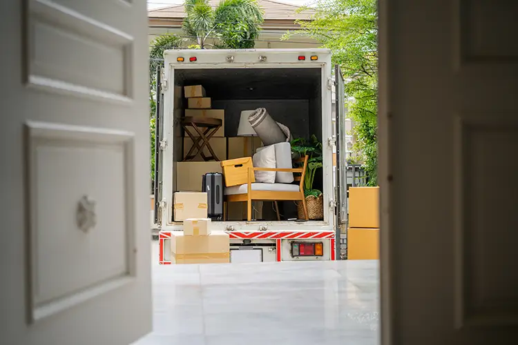 A moving truck with various boxes and items