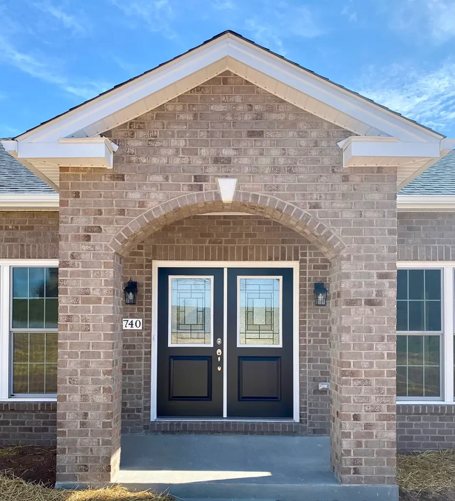 Close up of the front entrance of house with brown doors
