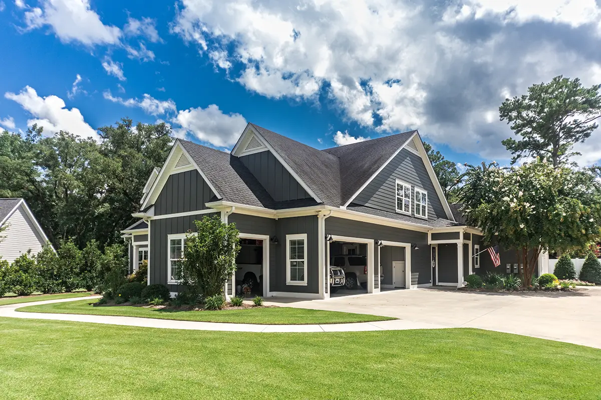 House with blue sky above and green well manicured lawn